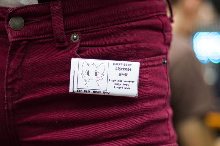 A plated titled "Boykissen license UwU &ndash; I can kiss however many boys I want UwU" affixed to a person's pants